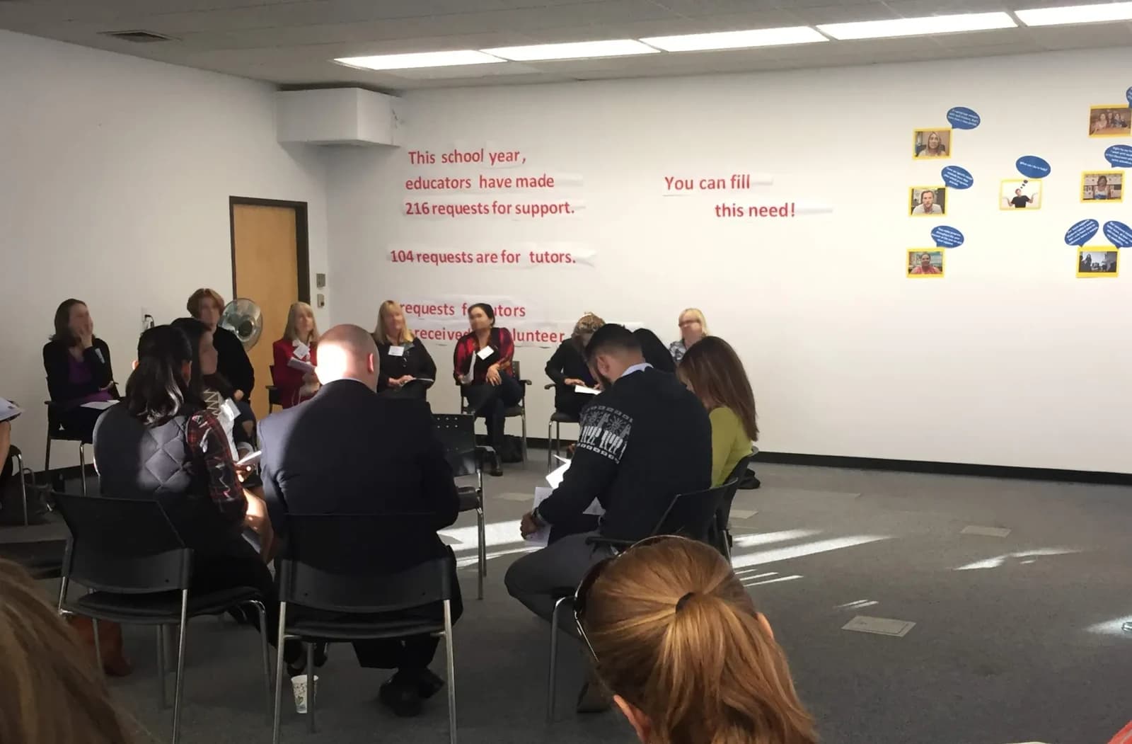 A strategic planning meeting in progress — nonprofit leaders and educators seated in a circle, working through community needs together.